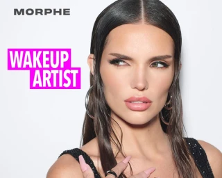 Close-up portrait of a woman with sleek dark hair and pink lipstick wearing hoop earrings for the Morphe WAKEUP ARTIST campaign.