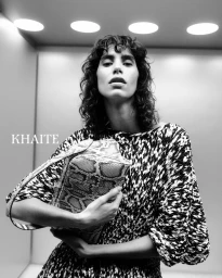 Model Mica Arganaraz holding a snakeskin handbag for Khaite S/S 2025 campaign photographed by Drew Vickers