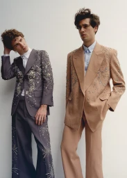 Two male models in embellished tailored suits standing against a plain white background for an Icon Magazine Australia editorial shoot.