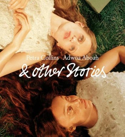 Two women lying on green grass outdoors wearing white textured tops in a campaign shot by Petra Collins for & Other Stories.