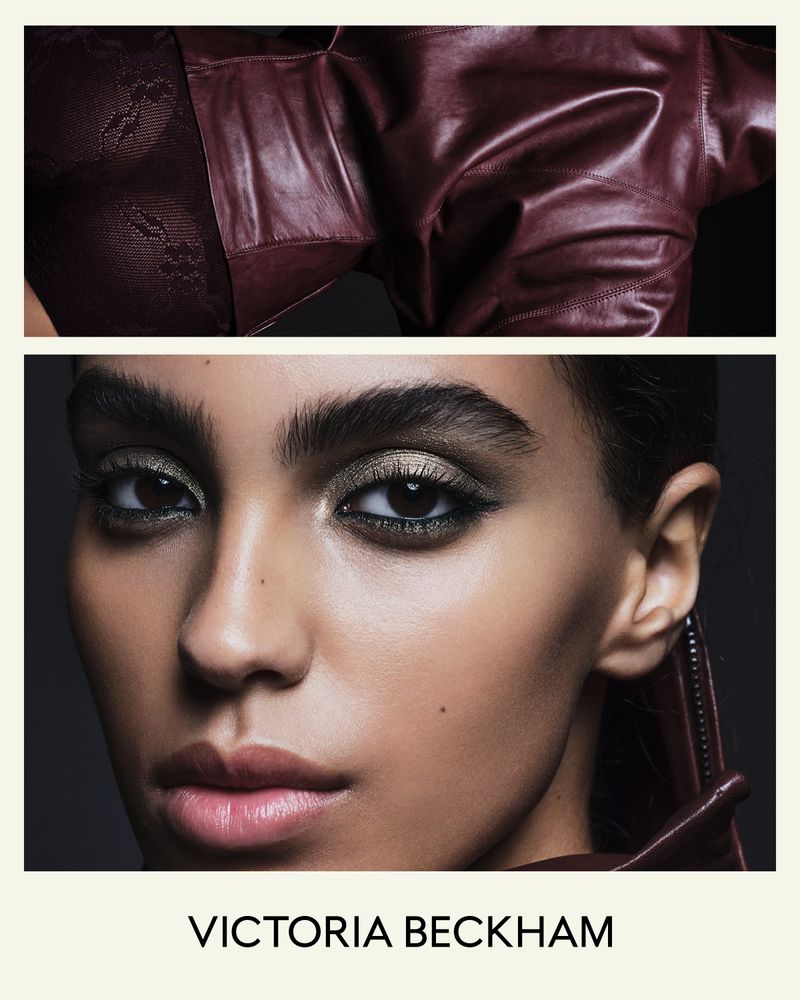 Close-up portrait of a woman with dramatic eye makeup wearing a maroon leather jacket. The model is identified as Victoria Beckham.