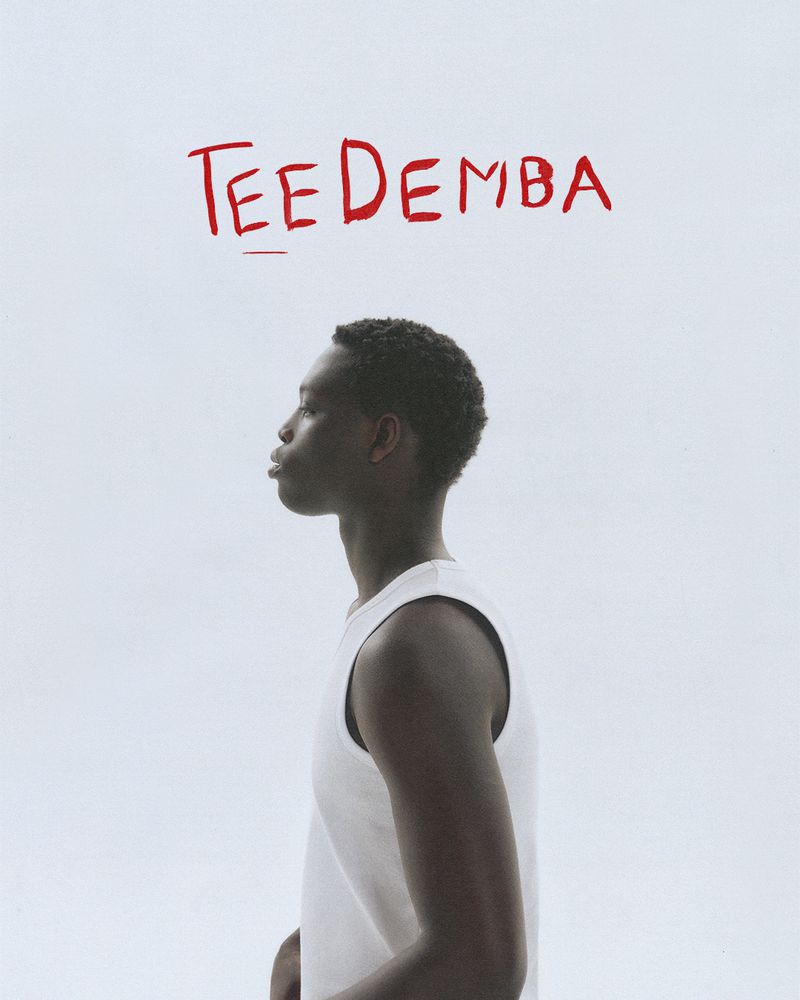 Profile shot of a young adult man wearing a white tank top against a white background with red handwritten text above.