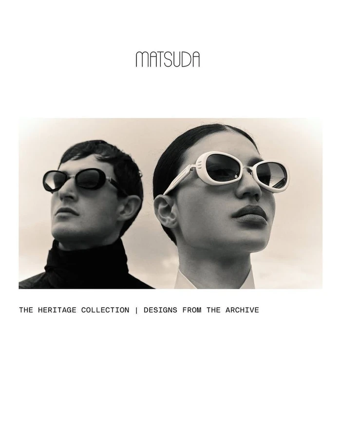 Two models wearing vintage sunglasses against a pale backdrop in a black and white editorial campaign image.